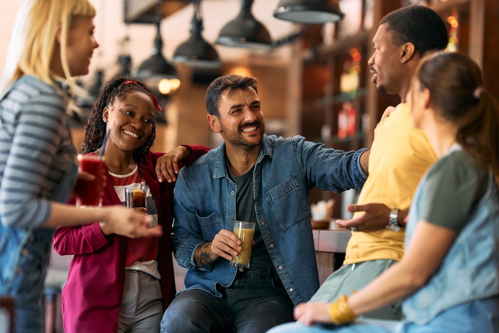 happy group of friends talking while having a drin 2026 03 16 03 29 41 utc