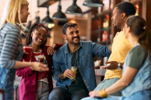 Articles 16 happy group of friends talking while having a drin 2026 03 16 03 29 41 utc
