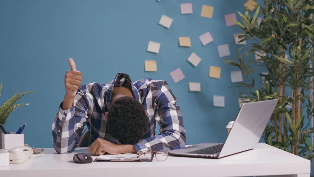 frustrated man resting head on desk at work 2026 03 19 02 05 55 utc copy