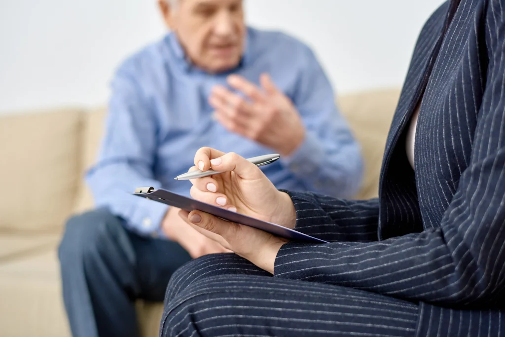 senior man talking with therapist at home on sofa 2026 03 19 09 20 20 utc copy